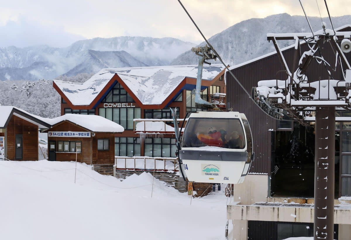 Rescue workers ride a gondola at a ski resort as they take part in a search for missing skiers following an avalanche the previous day, in the village of Otari in Nagano Prefecture (via REUTERS)