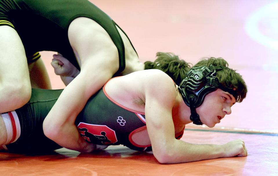 Perry's Brennan Warwick competes against Orrville's Caden Race in a 132-pound first round match at the McKinley Top Dawg Wrestling Invitational on Wednesday.