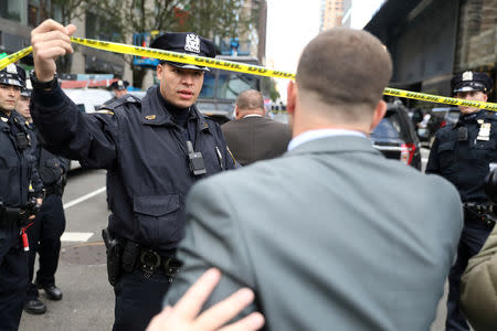 Police allow someone though the perimiter outside the Time Warner Center in the Manahattan borough of New York City after a suspicious package was found inside the CNN Headquarters in New York, U.S., October 24, 2018. REUTERS/Kevin Coombs