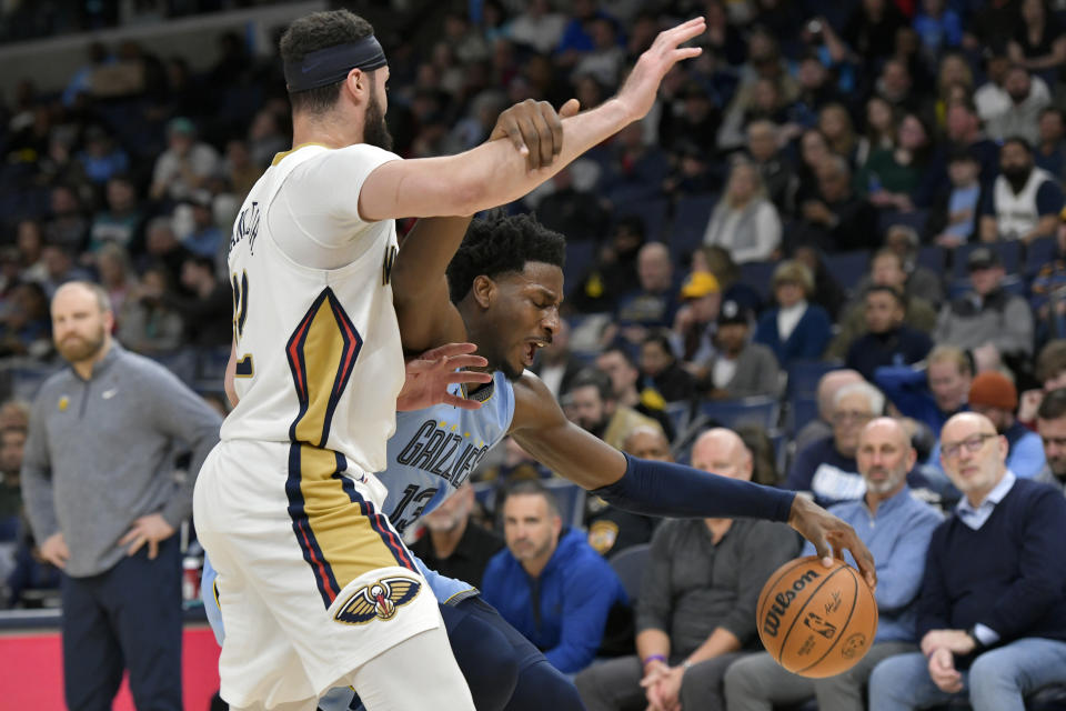 Memphis Grizzlies forward Jaren Jackson Jr. (13) handles the ball against New Orleans Pelicans forward Larry Nance Jr., front left, in the second half of an NBA basketball game Monday, Feb. 12, 2024, in Memphis, Tenn. (AP Photo/Brandon Dill)