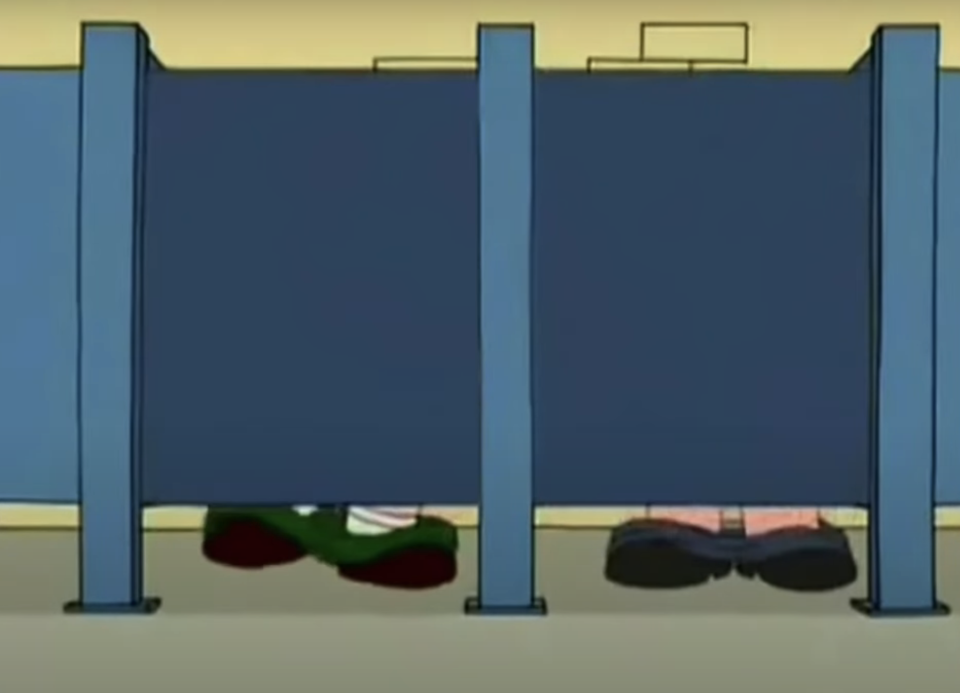 The image shows the feet of two individuals in a bathroom stall. One is wearing green shoes, the other is in black shoes