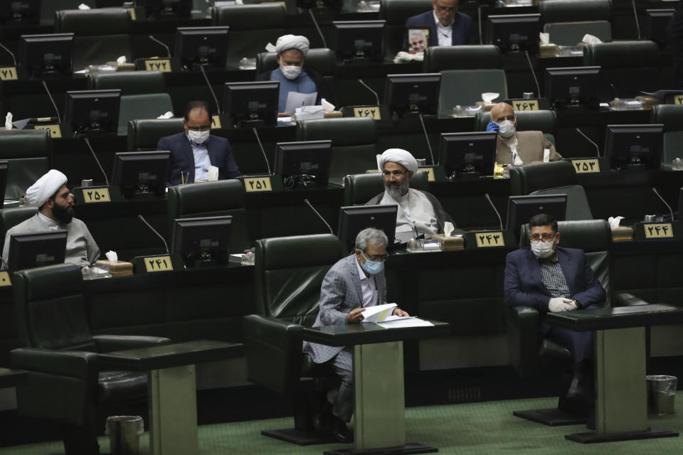 Lawmakers attend a session of the parliament in Tehran, Iran, Thursday, May 28, 2020. Iran's parliament elected Mohammad Bagher Qalibaf, a former mayor of Tehran tied to the Revolutionary Guard, as its next speaker Thursday, solidifying hard-line control of the body as tensions between the U.S. and the Islamic Republic remain high over its collapsed nuclear deal. (AP Photo/Vahid Salemi)