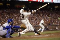 San Francisco Giants' Buster Posey drives in a run with a single against the Los Angeles Dodgers during the third inning of a baseball game Wednesday, April 16, 2014, in San Francisco. (AP Photo/Marcio Jose Sanchez)