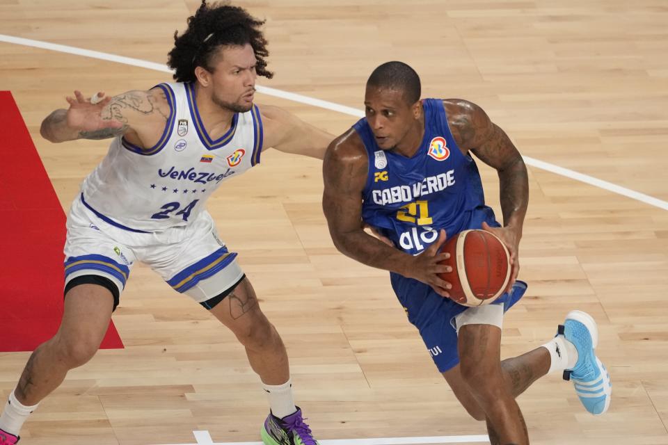 Cape Verde forward Betinho Gomes (21) drives against Venezuela forward Michael Carrera (24) in the first half of the Basketball World Cup group F match in Okinawa, southern Japan, Monday, Aug. 28, 2023. (AP Photo/Hiro Komae)