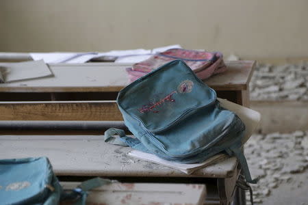 A schoolbag with the UNICEF logo rests on a desk inside a school damaged due to what activists said was an air strike carried out by the Russian air force in Aleppo countryside, January 12, 2016. REUTERS/Khalil Ashawi