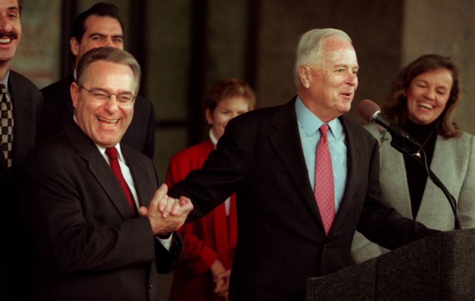 Mayor Richard Riordan at a news conference with former Councilman Joel Wachs, left.