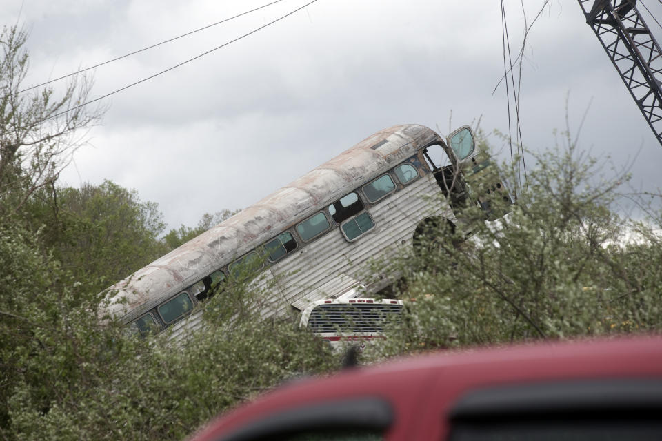 A bus that was taken by a tornado that touched down in Franklin County, Va., is viewed from Fishburn Mountiain Road, Friday, April 19, 2019. (Heather Rousseau/The Roanoke Times via AP)