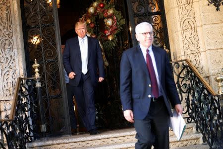 U.S. President-elect Donald Trump (L) watches from the door as Carlyle Group founder and CEO David Rubenstein (R) departs following their meeting at the Mar-a-lago Club in Palm Beach, Florida, U.S. December 28, 2016. REUTERS/Jonathan Ernst TPX IMAGES OF THE DAY