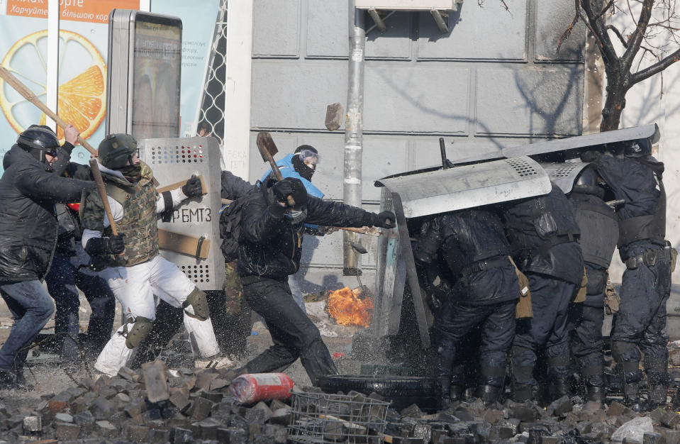 FILE - In this file photo taken on Feb. 18, 2014, anti-government protesters clash with riot police outside Ukraine's parliament in Kyiv, Ukraine. On Nov. 21, 2023, Ukraine marks the 10th anniversary of the uprising that eventually led to the ouster of the country’s Moscow-friendly president. (AP Photo/Efrem Lukatsky, file)