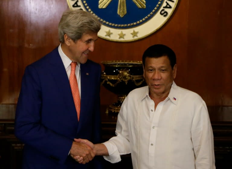 Philippine President Rodrigo Duterte (R) greets visiting US Secretary of State John Kerry, at the Malacanang presidential palace in Manila, on July 27, 2016