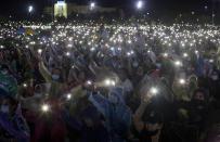 Pro-democracy protesters hold up mobile phone lights to live music during a rally at Sanam Luang in Bangkok, Thailand, Saturday, Sept. 19, 2020. Protesters gathered Saturday in Bangkok for the most ambitious rally so far in a pro-democracy campaign that has shaken up the government and the country's conservative establishment. (AP Photo/Gemunu Amarasinghe)