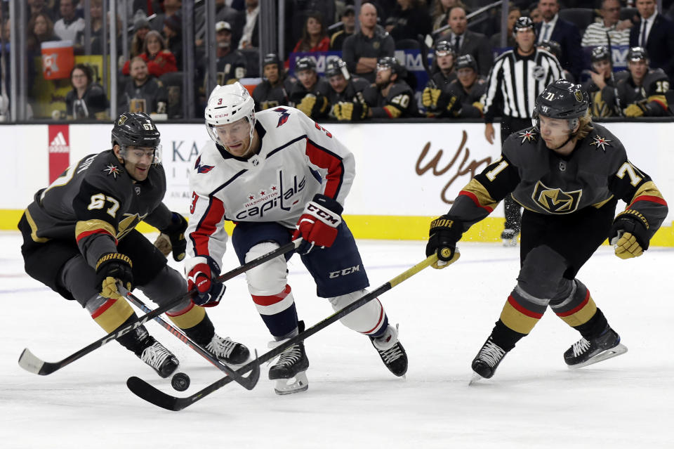 Vegas Golden Knights left wing Max Pacioretty (67) and center William Karlsson (71) defend as Washington Capitals defenseman Nick Jensen skates during the first period of an NHL hockey game Monday, Feb. 17, 2020, in Las Vegas. (AP Photo/Isaac Brekken)