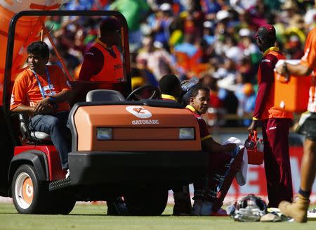 West Indies batsman Lendl Simmons (C) and team mate Jonathan Carter sit on the drinks cart during a break in their Cricket World Cup match against India in Perth, March 6, 2015. REUTERS/David Gray