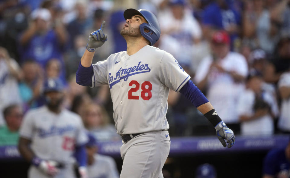 Los Angeles Dodgers' J.D. Martinez gestures as he crosses home plate after hitting a two-run home run against Colorado Rockies starting pitcher Connor Seabold in the third inning of a baseball game Tuesday, June 27, 2023, in Denver. (AP Photo/David Zalubowski)