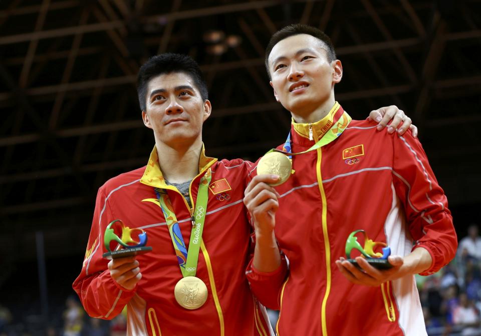 <p>Gold medallists Fu Haifeng (CHN) of China and Zhang Nan (CHN) of China pose on the podium. (Reuters) </p>