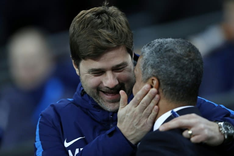 Tottenham Hotspur's manager Mauricio Pochettino (L) greets Brighton's counterpart Chris Hughton ahead of their English Premier League match, at Wembley Stadium in London, on December 13, 2017