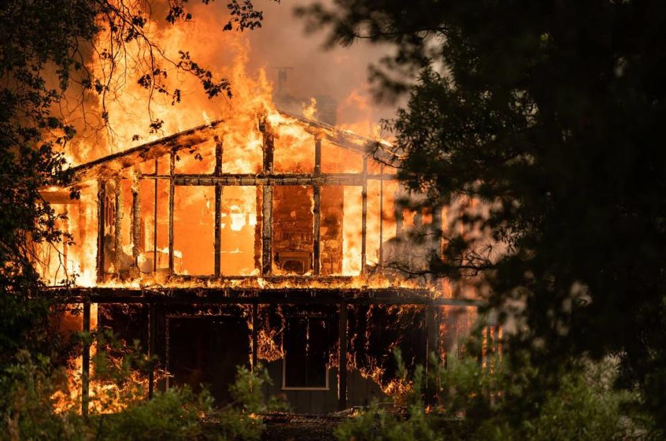 A fully involved house burns on the 16000 block of Mount Olive Road during the River Fire on Wednesday, Aug. 4, 2021, in Nevada County.