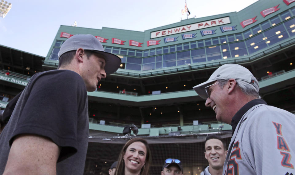 San Francisco Giants right fielder Mike Yastrzemski, left, talks with family and friends after batting practice prior to a baseball game against the Boston Red Sox at Fenway Park in Boston, Tuesday, Sept. 17, 2019. Yastrzemski is the grandson of Red Sox great and Hall of Famer Carl Yastrzemski. (AP Photo/Charles Krupa)