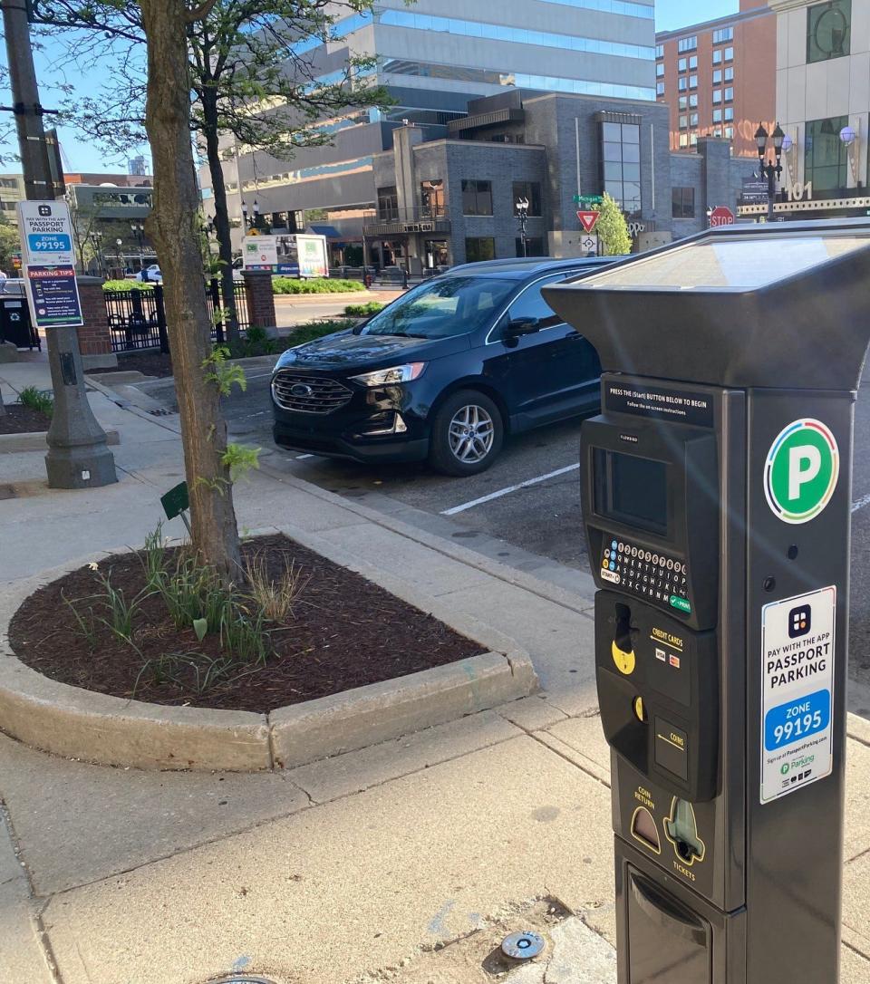 Parking kiosks have taken the place of old school meters all across downtown Lansing. Visitors can now pay with coins, credit cards or through the Passport app.