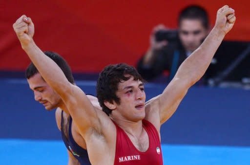 Iran's Hamid Soryan Reihanpour celebrates after defeating Azerbaijan's Rovshan Bayramov during their 55kg Greco Roman Wrestling Final match of the London 2012 Olympic Games at the Excel Centre in London. Soryan beat Bayramov to win the gold medal