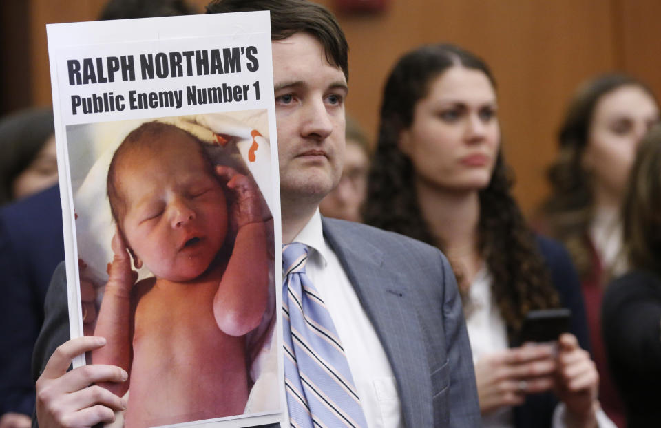 A demonstrator holds a sign as Virginia Gov. Ralph Northam, speaks during a press conference at the Capitol in Richmond, Va., Thursday, Jan. 31, 2019. Northam made a statement and answered questions about the late term abortion bill that was killed in committee. (Photo: Steve Helber/AP)