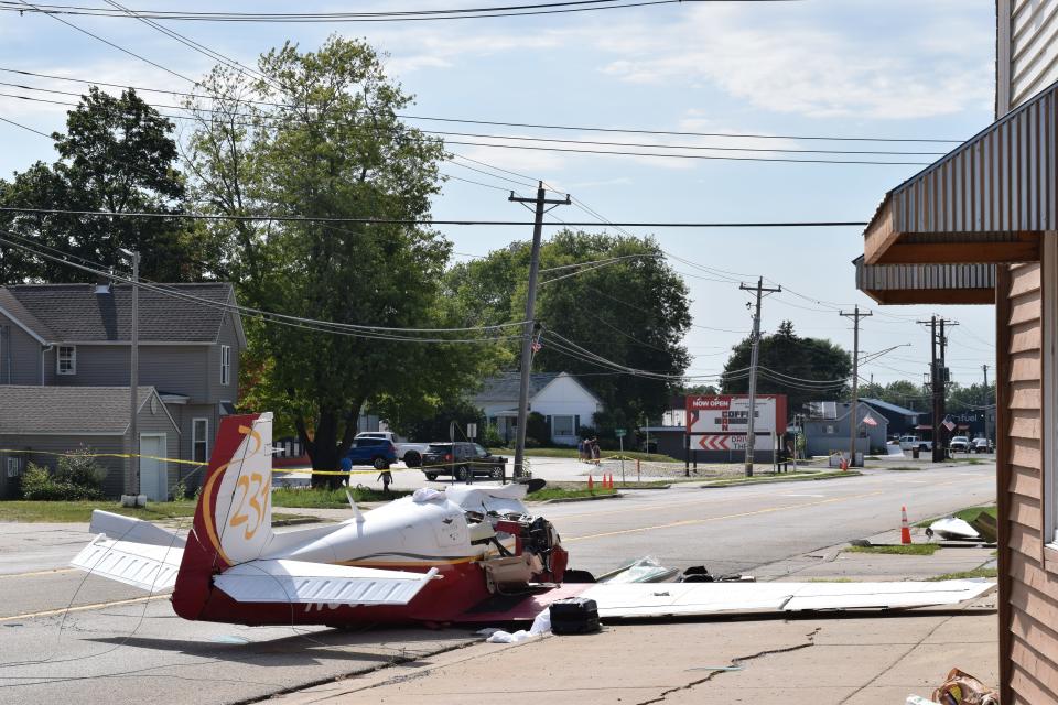 A plane sits outside of Gil's Supper Club in Hanna City after crashing on Route 116. Ron Gulley, owner of Coffee Can, ran to the scene after watching the plane skid by.