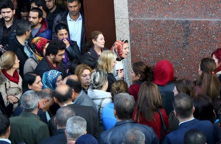 People wait in front of a hospital morgue where killed Bar Association President Tahir Elci is brought for an autopsy in Kurdish dominated southeastern city of Diyarbakir, Turkey, November 28, 2015. REUTERS/Sertac Kayar