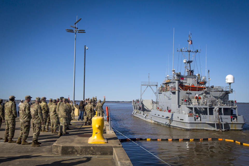 A group of soldiers from 7th Transportation Brigade (Expeditionary) wave to the crew of LLV Monterey as it pulls out from port on a humanitarian mission to Gaza, on Tuesday, March 12, 2024, at Joint Base Langley-Eustis in Hampton, Va. (AP Photo/John C. Clark)