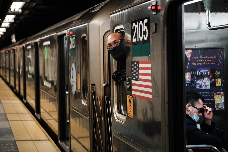 A subway train conductor looks down the platform at a New York City subway station on April 13, 2021 in New York City.  / Credit: Getty Images