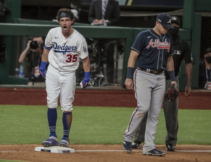 Arlington, Texas, Tuesday, October 13, 2020. Los Angeles Dodgers center fielder Cody Bellinger (35) yells out "let's go!" to teammates after hitting an rbi triple in the bottom of the ninth to bring the Dodgers within a run of the Braves in game two of the NLCS at Globe Life Field. (Robert Gauthier/ Los Angeles Times)