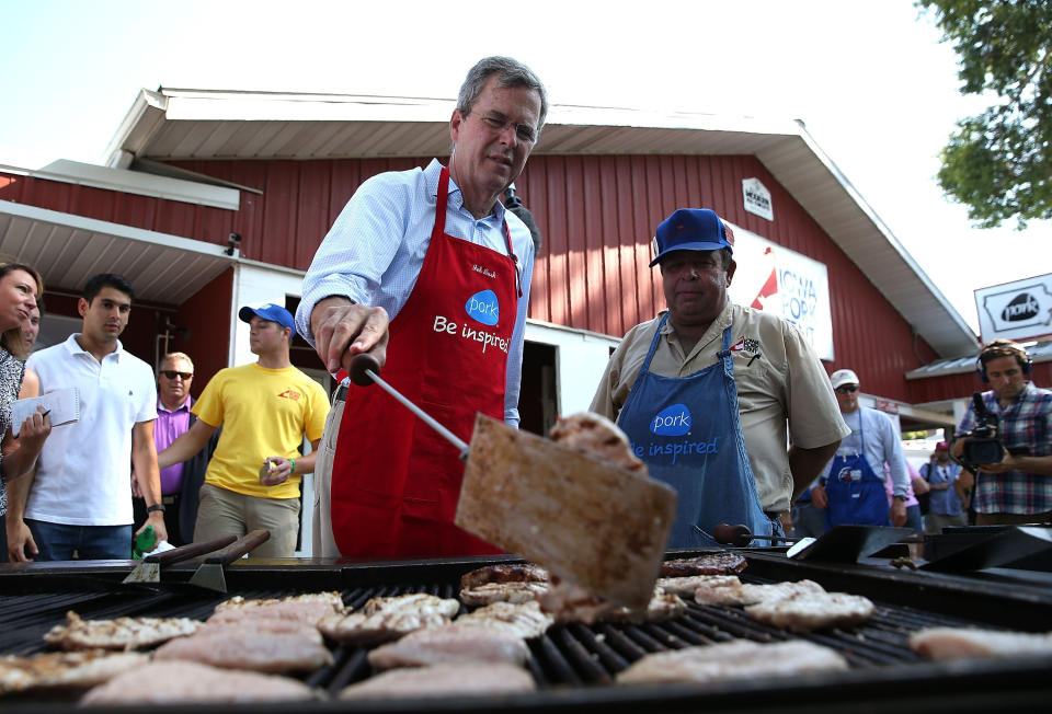 <p>Former Florida Gov. Jeb Bush (R) flips a pork chop on a grill at the Iowa Pork Tent.</p>