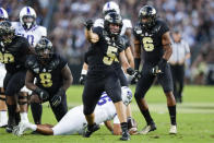 In this photo taken on Saturday, Sept. 14, 2019, Purdue defensive end George Karlaftis (5) celebrates a tackle against TCU during the first half of an NCAA college football game in West Lafayette, Ind. With 6-3, 325-pound Lorenzo Neal manning the middle and freshman All-American George Karlaftis back at defensive end, the Boilermakers defense should be stingier than the last year's unit. (AP Photo/Michael Conroy)