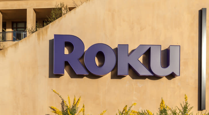 The Roku logo on the side of an office building comprised of sand colored concrete