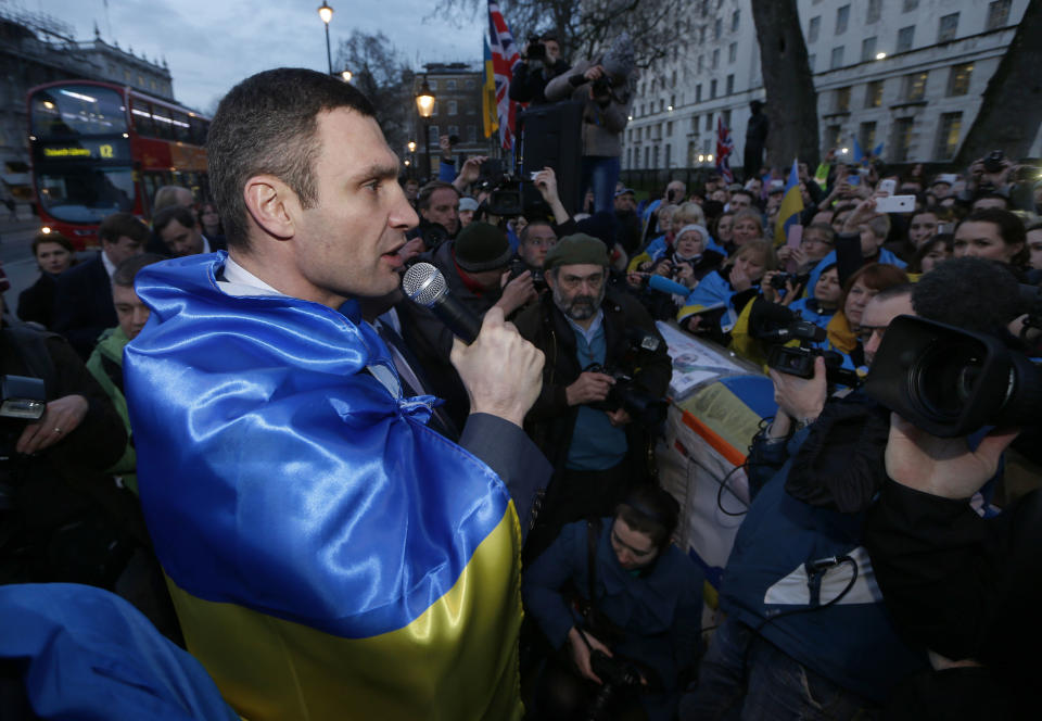 Ukraine's MP Vitali Klitschko, leader of the UDAR (Ukrainian Democratic Alliance for Reform) party addresses protesters outside 10 Downing Street in London after a meeting with British Prime Minister David Cameron and Foreign Secretary William Hague, Wednesday, March 26, 2014. (AP Photo/Sang Tan)