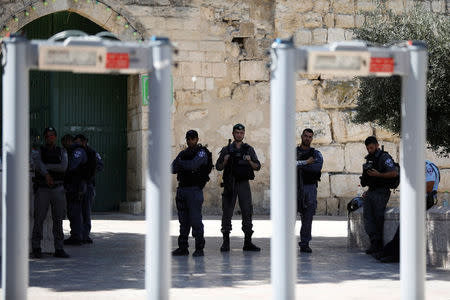 Israeli border police and police officers stand guard next to newly installed metal detectors at an entrance to the compound known to Muslims as Noble Sanctuary and to Jews as Temple Mount, in Jerusalem's Old City July 16, 2017. REUTERS/Ronen Zvulun