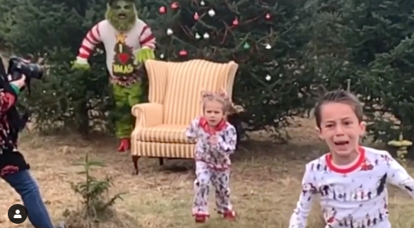 Still of video of kids being scared by Grinch during a Christmas card photo shoot. 