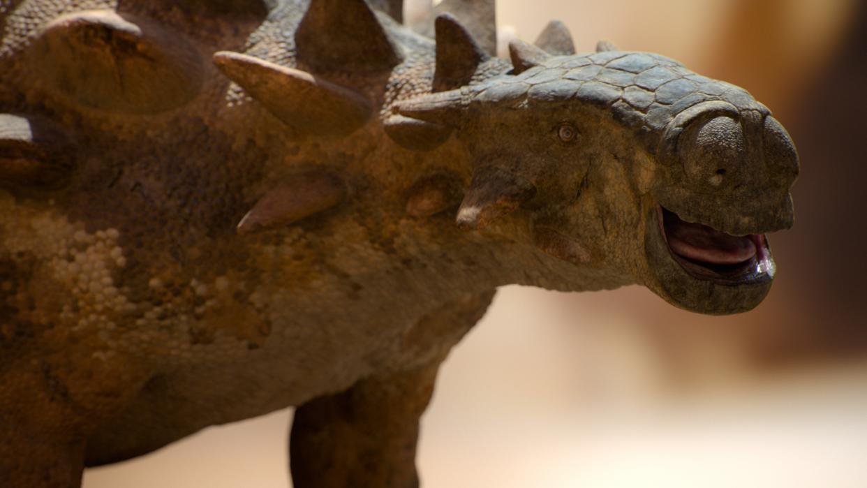  A close up of a Tarchia in Prehistoric Planet shows its scaly skin, armored head and large nose. 