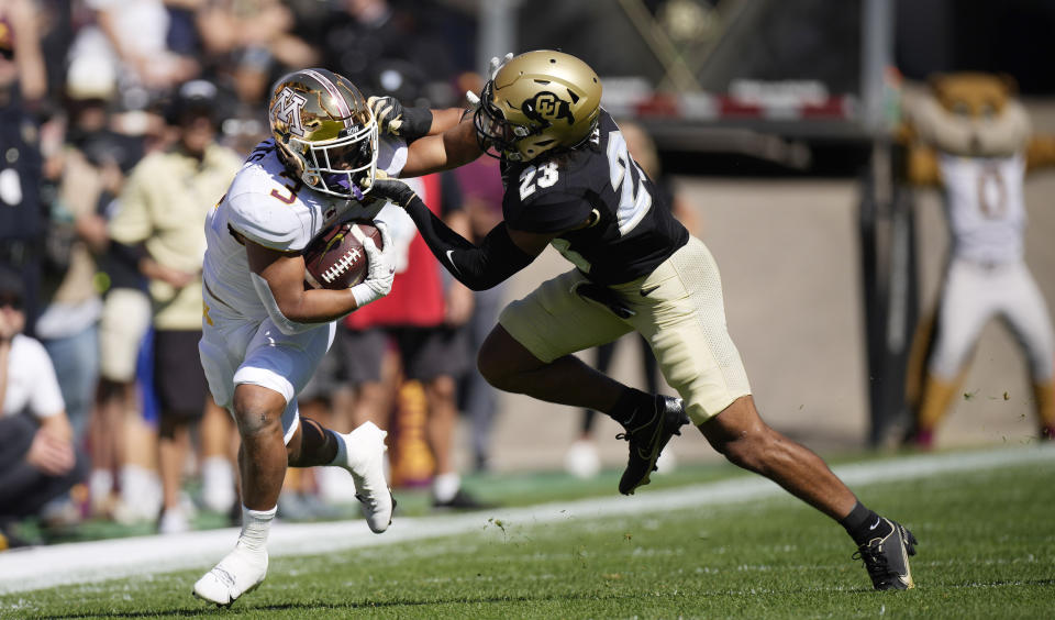 Minnesota running back Treyson Potts, left, is stopped by Colorado safety Isaiah Lewis in the first half of an NCAA college football game Saturday, Sept. 18, 2021, in Boulder, Colo. (AP Photo/David Zalubowski)