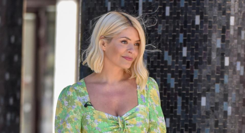 Holly Willoughby sat on a garden chair as she got to work with edits for her upcoming book. (Getty Images)