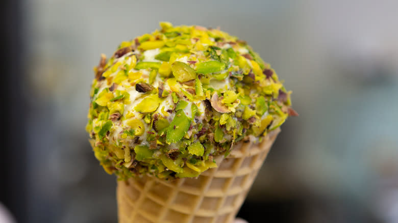 ice cream cone topped with pistachio