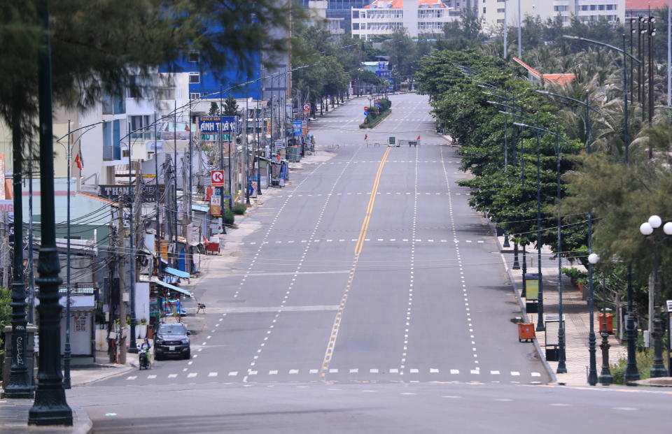 A deserted street is blocked during a virus lockdown in Vung Tau, Vietnam on Sept. 13, 2021. More than a half of Vietnam is under a lockdown order to contain its worst virus outbreak yet. (AP Photo/Hau Dinh)