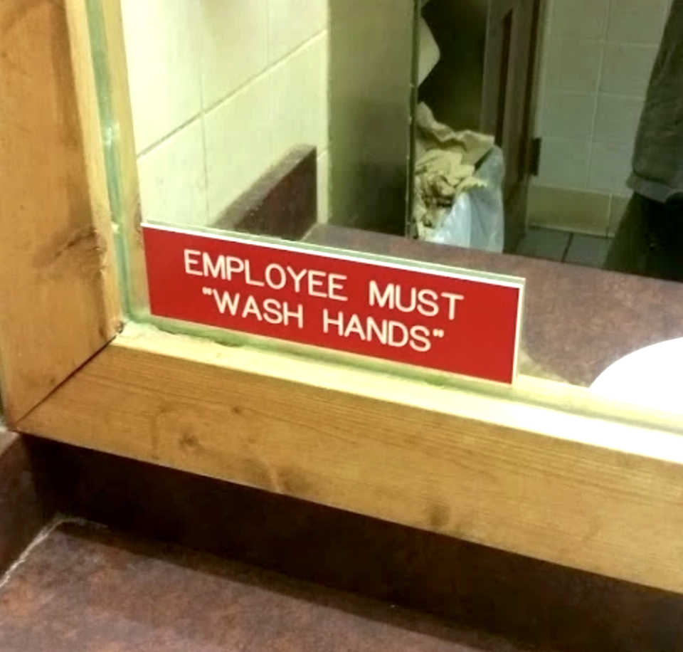 A sign that reads, "employees must 'wash hands'"