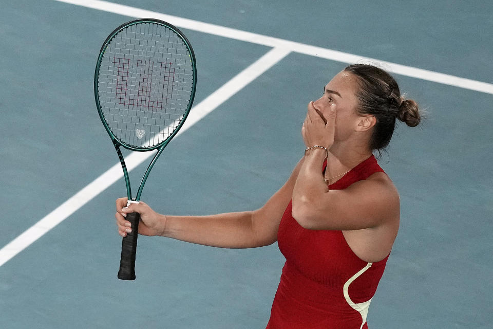 Aryna Sabalenka of Belarus celebrates after defeating Zheng Qinwen of China in the women's singles final at the Australian Open tennis championships at Melbourne Park, Melbourne, Australia, Saturday, Jan. 27, 2024. (AP Photo/Louise Delmotte)