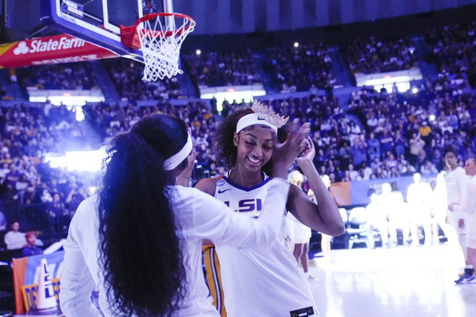 LSU forward Amani Bartlett places a tiara on forward Angel Reese during player introductions before the start of a second-round college basketball game against Middle Tennessee in the women's NCAA Tournament in Baton Rouge, La., Sunday, March 24, 2024. (AP Photo/Gerald Herbert)