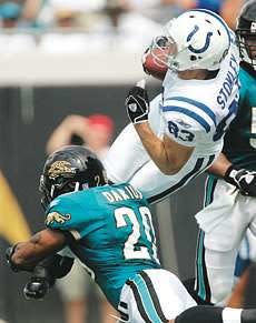 Indianapolis wide receiver Brandon Stokley leaps for yardage as Jacksonville\'s Donovan Darius came up to make the hit during Sunday\'s game in Jacksonville. Stokley led the Colts with 98 yards receiving as Indy handed the Jaguars their first loss of the season, 24-17. AP Photo.