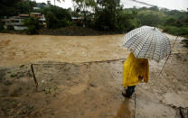 <p>A men stands near Tiribi river, flooded by heavy rains from Tropical Storm Nate in San Jose, Costa Rica, Oct. 5, 2017. (Photo: Juan Carlos Ulate/Reuters) </p>
