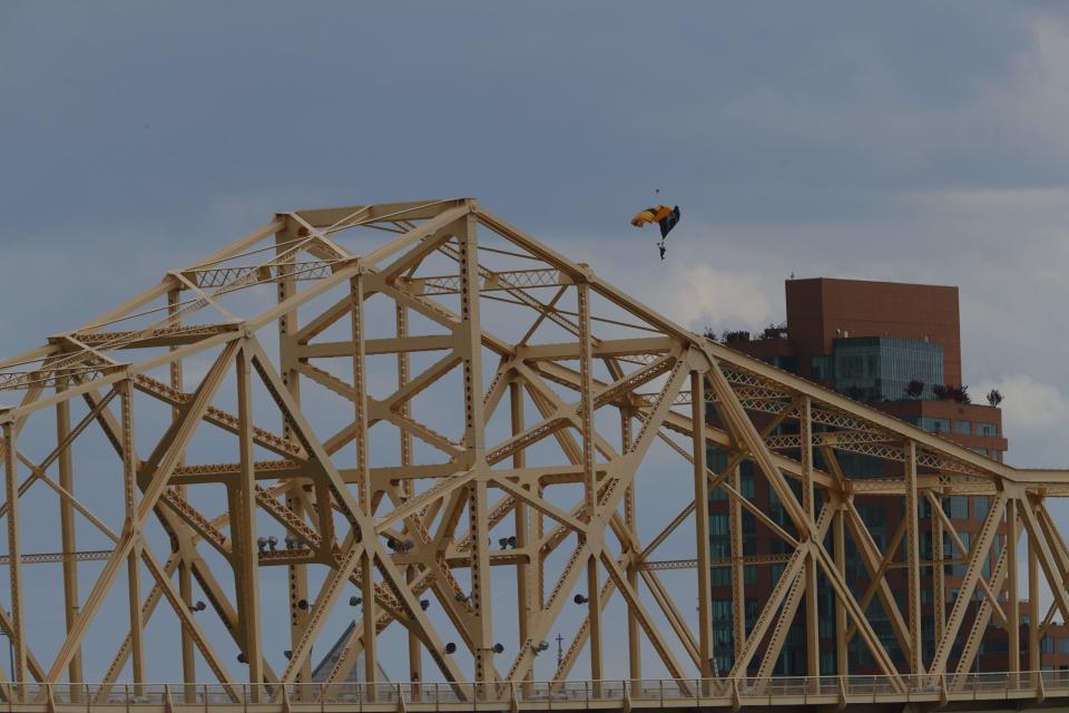 A parachutist floats down to the Ohio River during the airshow at Thunder Over Louisville. April 22, 2023.