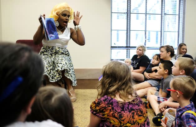 Drag performer Champagne Monroe reads a children's book titled 