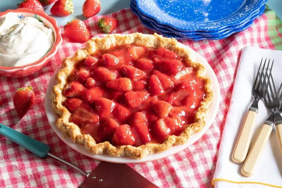 strawberry pie on checkered linen with blue plates
