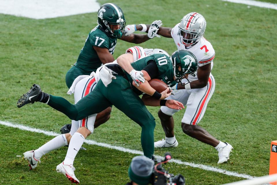 Michigan State quarterback Payton Thorne (10) scores against Ohio State during the second half at the Spartan Stadium in East Lansing on Saturday, Dec. 5, 2020. It was just one of two rushing touchdowns in the 2020 season for the Spartans, neither by a running back.